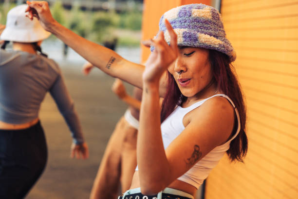 Professional dancer performing with the team in the city street Group of four young females professional dancers dressed with urban clothes performing in the city streets in New York. alternative lifestyle stock pictures, royalty-free photos & images