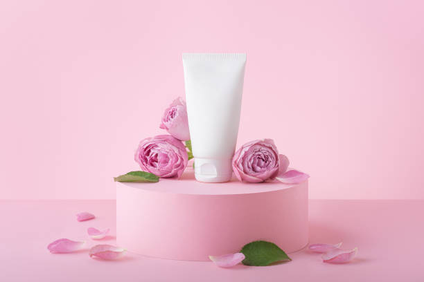 istock Tube with cream on a pink background with roses 1437070851