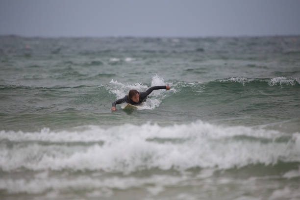 istock Athletic male surfing sea waves 1437070931