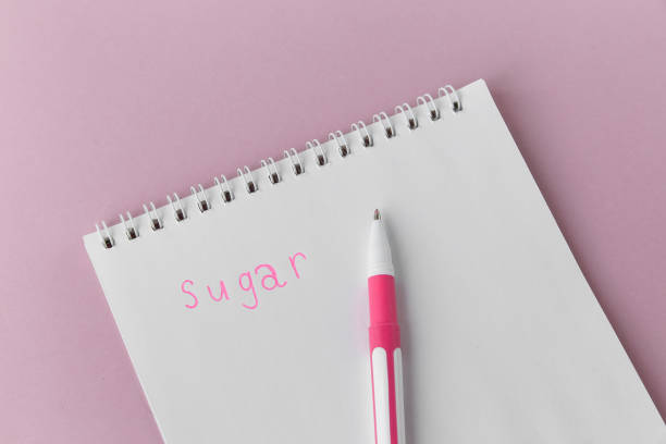 istock Notepad and pen on a pink background, the inscription sugar 1437073304