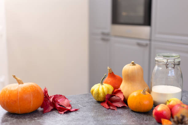 istock Beautiful orange pumpkins on the kitchen table. 1437073353