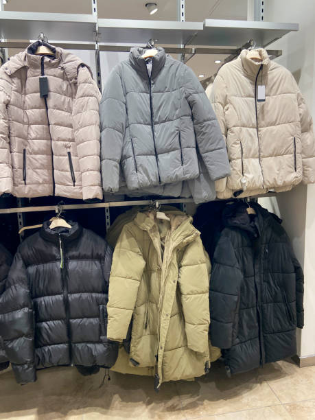 istock Coats hanging in the clothing store shelf 1437073452