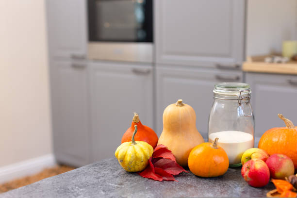 istock Beautiful orange pumpkins on the kitchen table. 1437073469