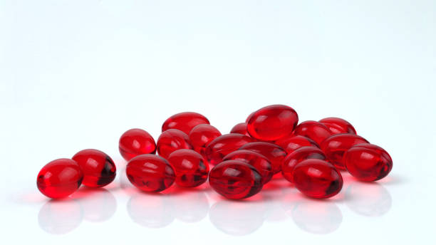 istock Red transparent oval capsules with vitamins. 1437075109