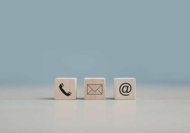 istock Customer support hotline Contact us people connection. cube wood with the email, call phone, address, and Chat message icons. Website page contacts us or e-mail marketing concept, copy space. 1437077144