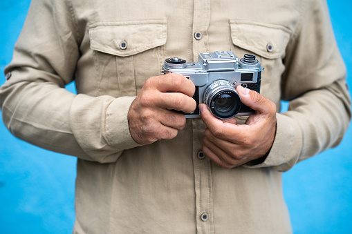 Unrecognisable man holding a vintage camera