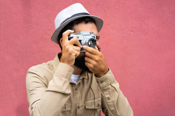 istock Side view of a man making a photo with a retro camera 1437077189