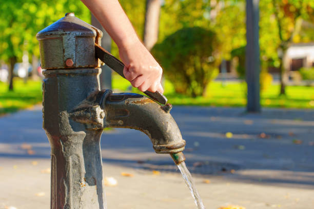 istock Pumping water from the hand pump well 1437081781