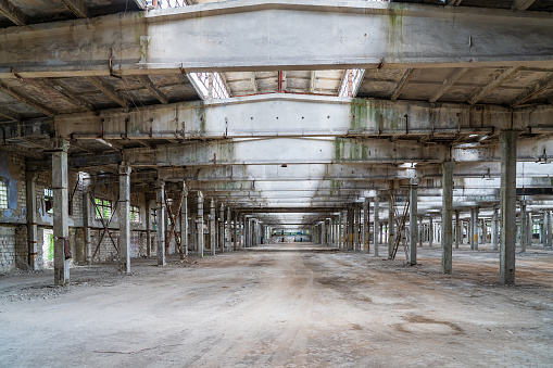 Interior of a large empty historic warehouse with brick walls being prepared for a restoration