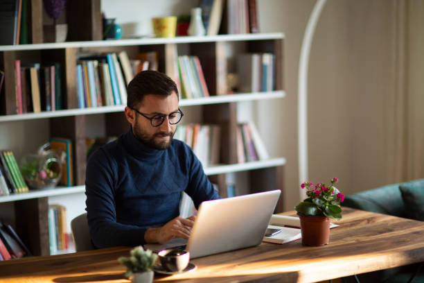 istock Young man working at home in the evening 1437085884