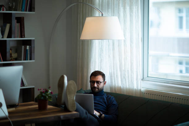 istock Young man working at home in the evening 1437085924