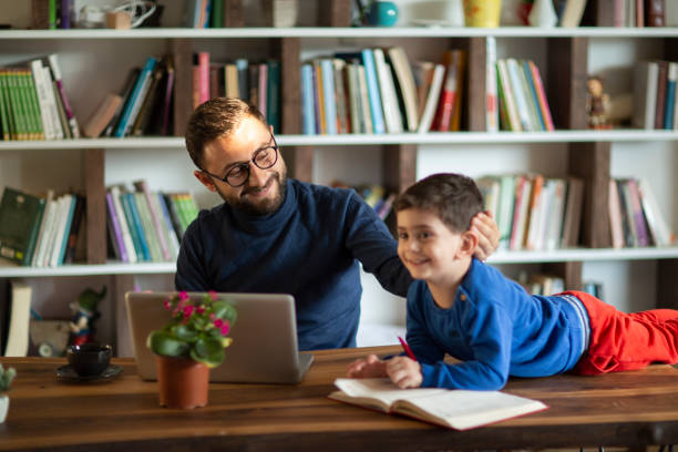 istock Father and daughter working together at home 1437087137