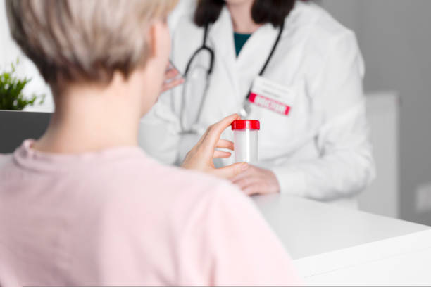 istock The doctor gives his patient a transparent jar for testing. 1437087330