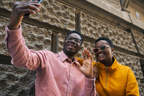 istock Young attractive black couple taking a selfie 1437087361