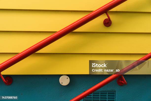 Red Handrail Against Yellow Wall Stock Photo - Download Image Now - Construction Industry, Tube, Tubing