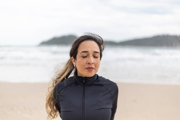 istock Latin woman performing physical exercises on the beach 1437093563