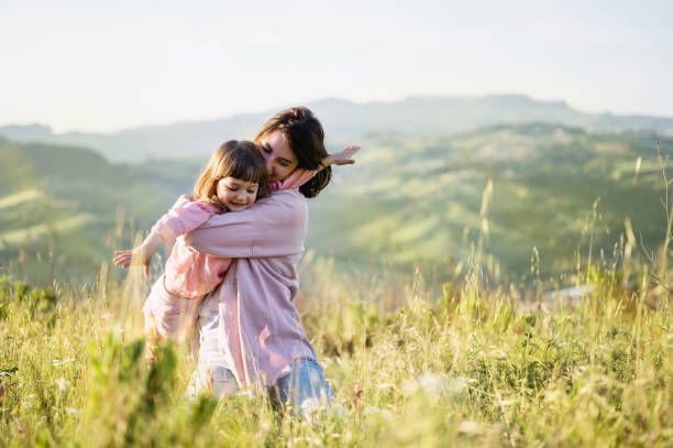 istock Happy family: mother and child daughter on sunset. 1437094752