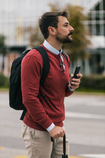 young it expert waiting for a ride to work - color image bus discussion expertise imagens e fotografias de stock