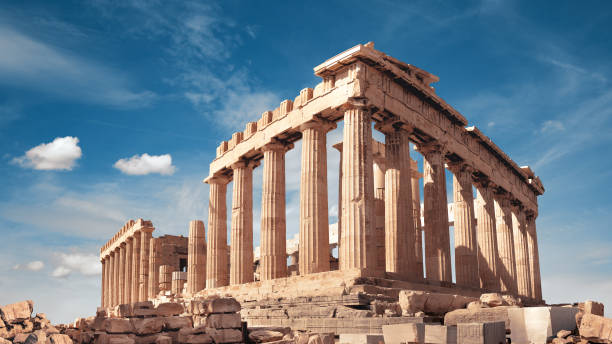 Parthenon temple in Acropolis in Athens, Greece. Panoramic image, sunny day, blue sky with clouds. stock photo