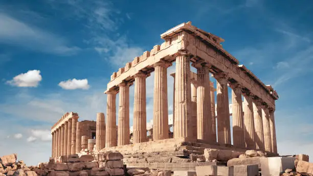 Parthenon temple in Acropolis in Athens, Greece. Panoramic image on a bright sunny day, blue sky with clouds.