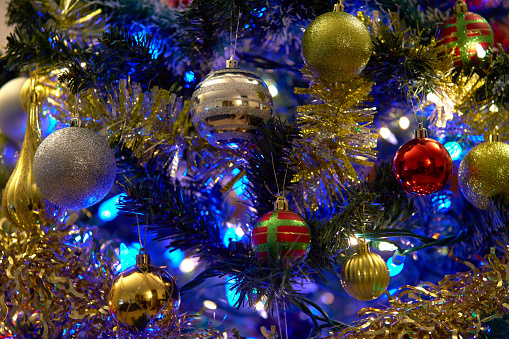 Festive holiday decorations on a Christmas tree.