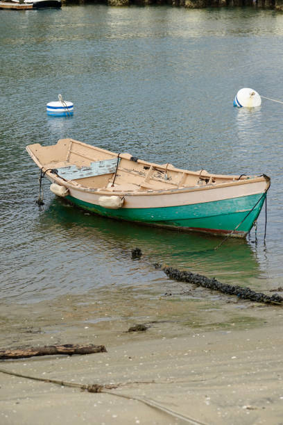 istock Old fashioned wood boat beached on the sand 1437111881
