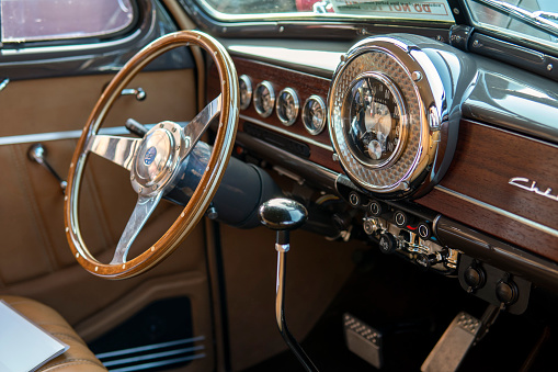 Brown interior of Chevrolet Bel Air, retro torpedo car, vintage steering wheel, speedometer. Snohomish, WA, USA - September 2022