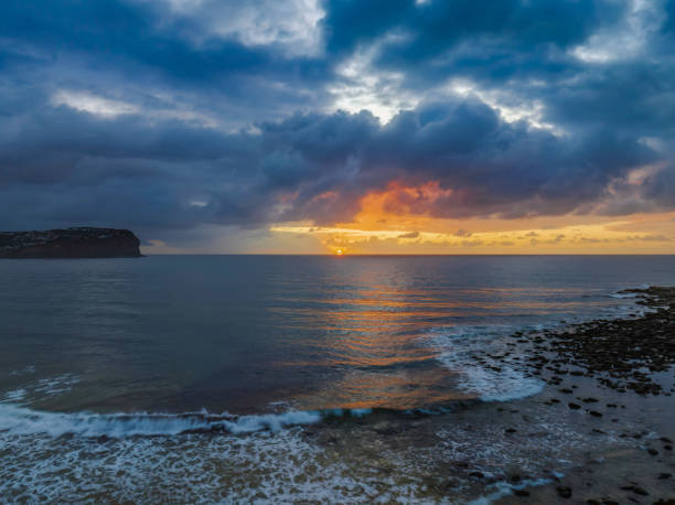 istock Drizzly moody sunrise seascape with cloud filled sky 1437116759