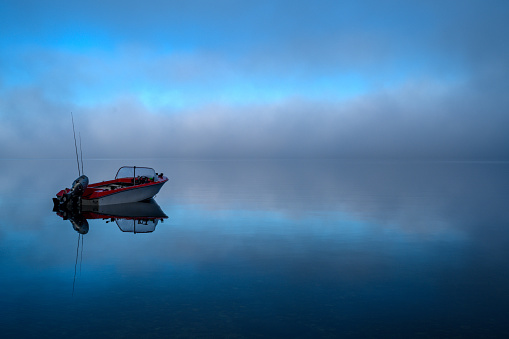 Boat on a foggy Kennedy Lake, Tofino, Vancouver Island, BC Canada