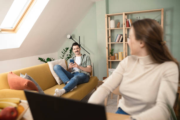 istock Woman working at her home office and her husband using smartphone and enjoying 1437123572