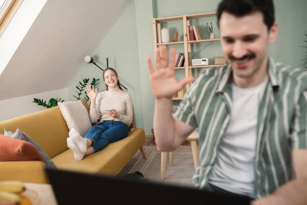 istock Man working online while his wife using smartphone on the sofa 1437123593
