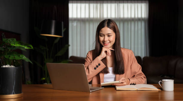 istock Young asian female office worker and working on computer laptop. 1437133950
