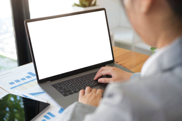 istock Focused businesswoman using laptop computer at bright modern office. 1437134801