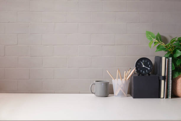 istock Comfortable workplace with picture frame, coffee cup, notebook and house plant. Home office desk, Copy space for your text. 1437136865