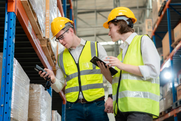 istock Managers, warehouse workers use machines to scan material numbers in large warehouses. 1437137612