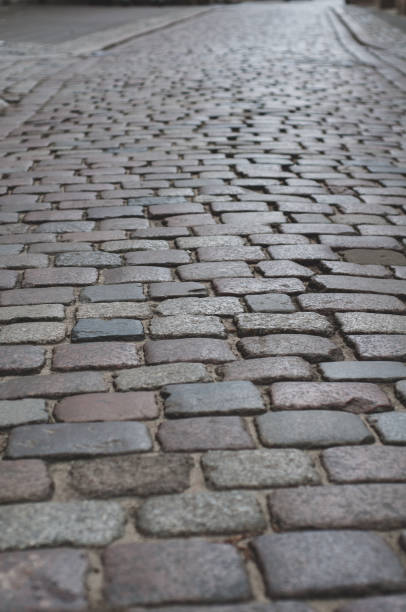 istock Old pavement lined with stone, stone pavement background close-up 1437137680