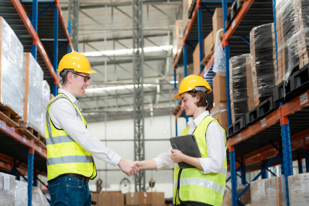 istock Engineers are working together with smiles in a large warehouse. 1437137690