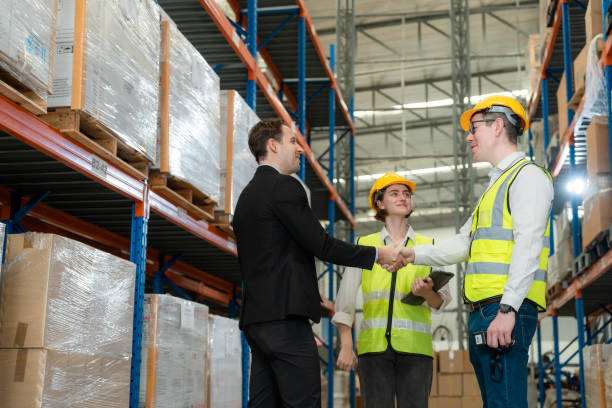 istock Successfully completed work. A man and a woman in a business suit shake hands and conclude a deal for the warehouse business. A businesswoman and a businessman at work successfully make a deal 1437137730