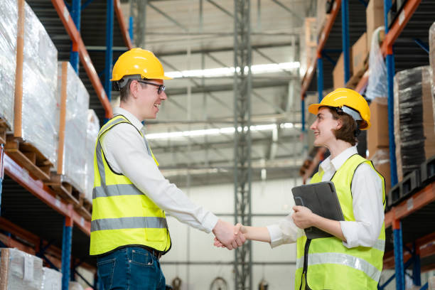istock Engineers are working together with smiles in a large warehouse. 1437137741