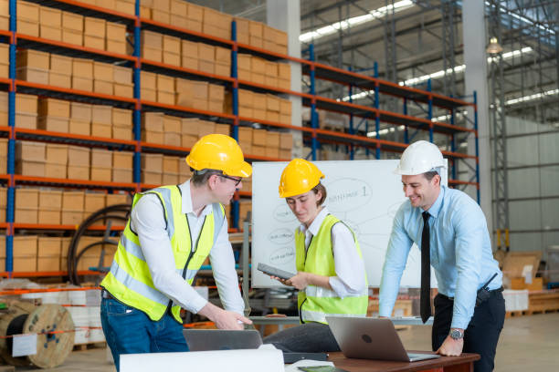 istock Engineers, employees, businessmen talking in large warehouses. 1437137787