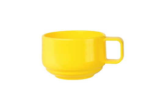 Stylish yellow plastic mug isolated on a white background. Minimal concept of plastic tableware.