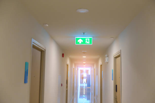 istock Fire Emergency exit sign on the wall background inside building. Safety concept 1437153565