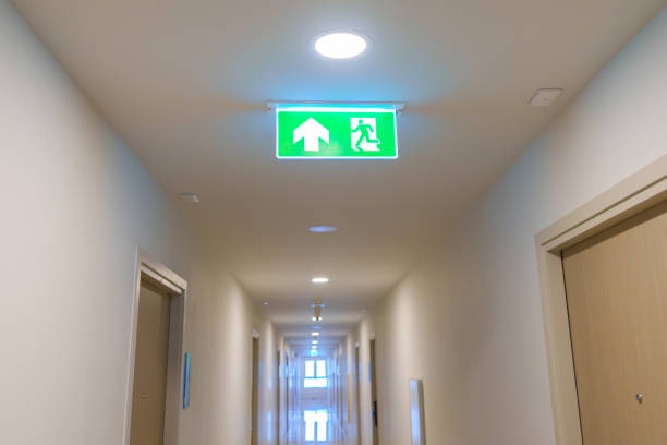 istock Fire Emergency exit sign on the wall background inside building. Safety concept 1437153624