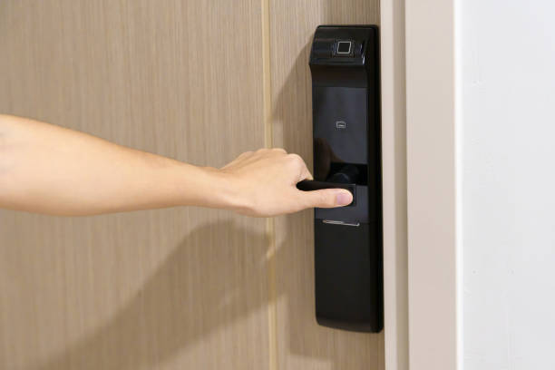 istock man holding handle of smart digital door lock while open or close the door. Technology, electrical and lifestyle concepts 1437153685