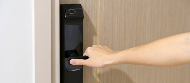 istock man holding handle of smart digital door lock while open or close the door. Technology, electrical and lifestyle concepts 1437153700