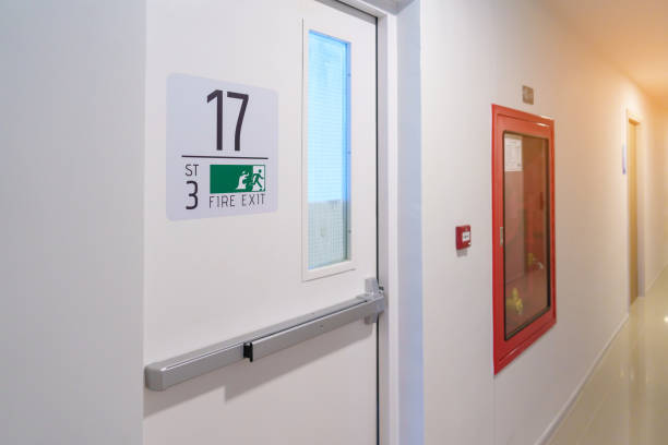 istock Fire extinguisher system on the wall with Fire Exit door sign for emergency. Stairwell fire for escape in building or apartment 1437153704
