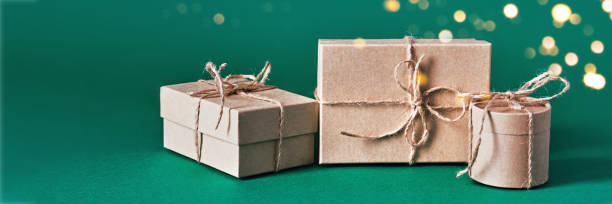 istock Christmas banner with sustainable gift boxes composition on green background. Christmas zero waste 1437156984