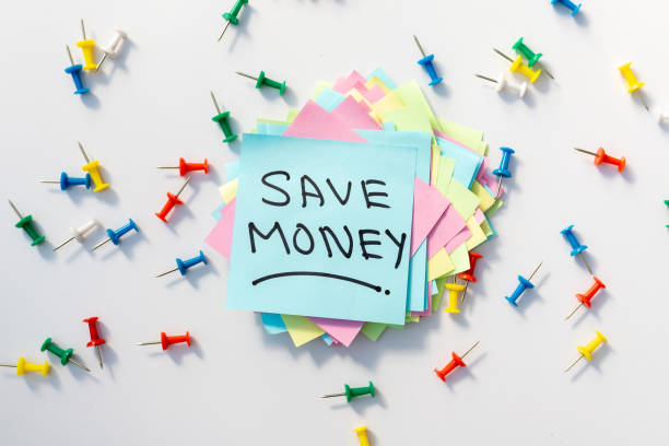istock Save Money sticky note with a colorful push pins and white background 1437166544