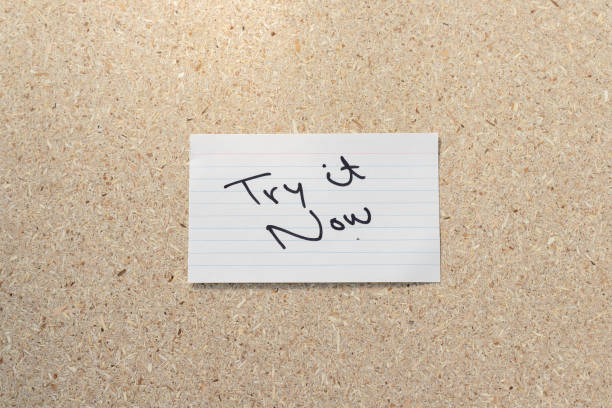 istock Try it now motivational quote handwritten sticky note on cork board background 1437167230