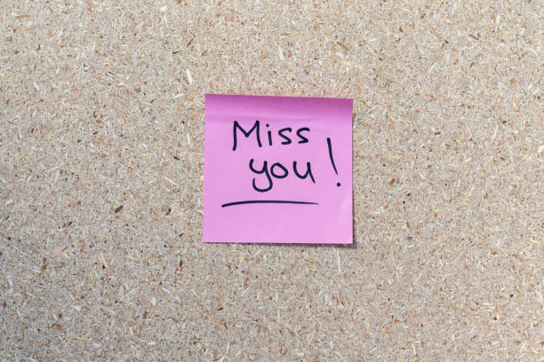 istock A hand written reminder note of a text Miss You on a pink sticky note 1437168142